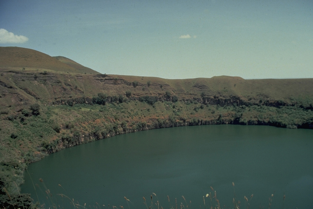 The 1-km-wide, lake-filled Ara-Shetan maar is located at the S end of the Butajiri-Silti volcanic field. It consists of a large group of basaltic scoria cones, maars, and lava flows in an 80-km-long, NE-SW-trending area near the W margin of the Ethiopian Rift. At least 13 maars, many filled by lakes, are located near the town of Debre Zeit, SE of Ethiopia's capital city, Addis Ababa.  Photo by Giday Wolde-Gabriel (Los Alamos National Laboratory).