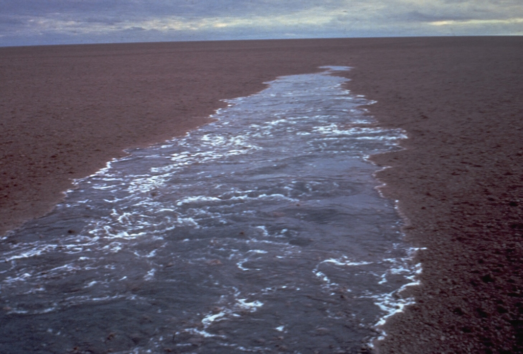  A raft of floating pumice from a July 1973 submarine eruption behind the wake of a ship. This was the first report of an eruption from the Curacoa submarine volcano in the northern Tonga Islands. The pumice raft covered an area of more than 100 km2 and was encountered by a ship 200 km to the W nearly two weeks after the start of the eruption. Another eruption was observed in the same general area in 1979. Photo by the crew of the vessel 