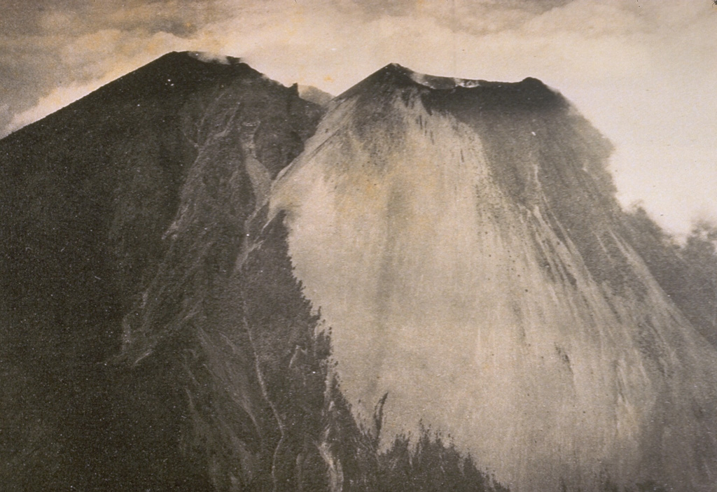 A view of Lamongan volcano from the west shows the forested summit of Gunung Tarub, forming the highest point on the volcano to the left, with a younger, sparsely vegetated cone (Gunung Lamongan) constructed to the SW. A volcanic spine was located in the summit crater, which has been the source of most historical eruptions. Photo published in Taverne, 1926 