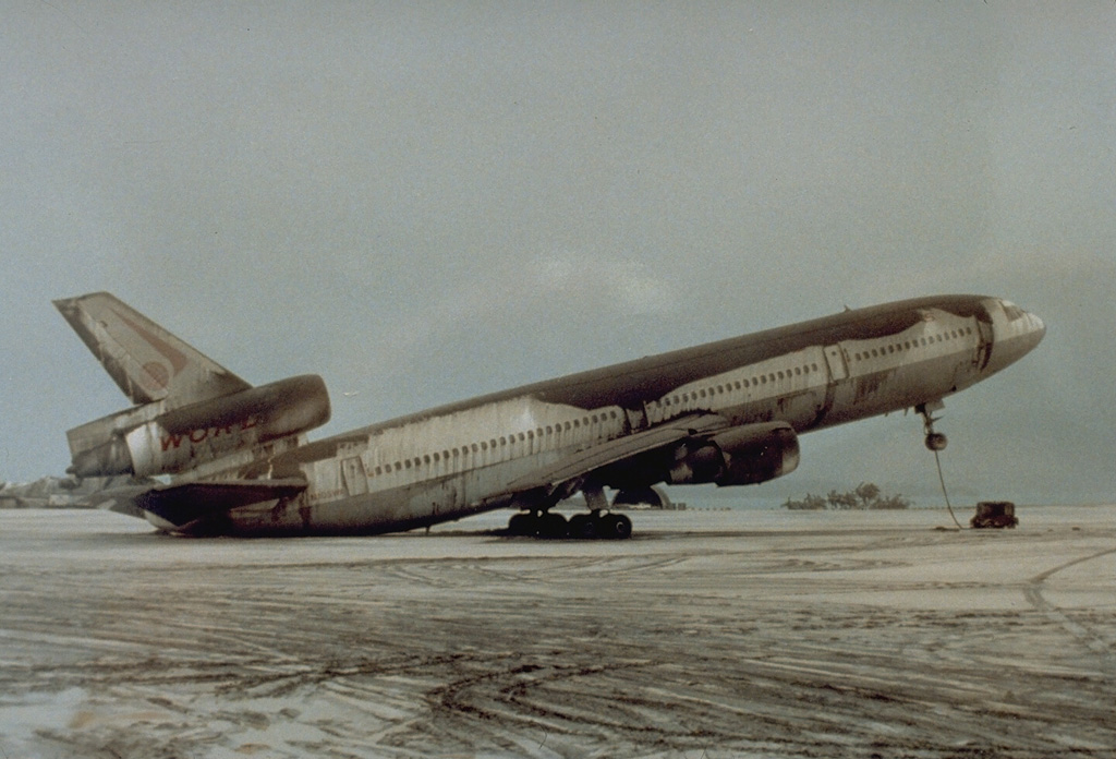 Volcanic ash is composed of heavy pulverized rock. Ashfall from the 15 June 1991 eruption of Pinatubo in the Philippines accumulated on this this World Airways DC-10, shifting the center of gravity and causing the nose to tip up. About 4 km3 of ash was erupted on 15 June. It accumulated to depths of 10-15 cm at this airfield at the Cubi Point Naval Air Station, 40 km SSW of Pinatubo. Photo by R.L. Rieger, 1991 (U.S. Navy).