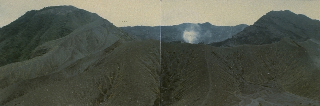 A small plume rises from Kaba Kecil, the middle of three summit craters on Kaba volcano, viewed from the ENE at Vogelsang Peak on the upper NNE flank. The Bukit Biring peak is to the left of Kaba Kecil crater and Bukit Kaba peak is to the right. The far wall of Kaba Lama crater, the largest crater at Kaba, forms the center horizon. Photo by Deddy Rochendi, 1981 (Volcanological Survey of Indonesia).