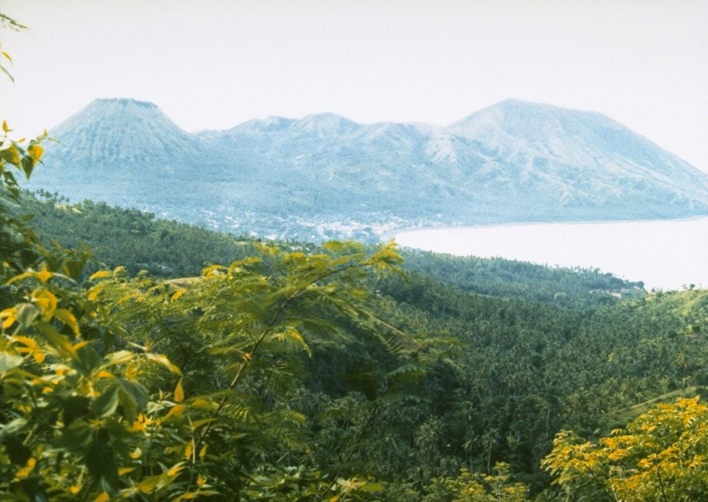 Gunung Iya (right), next to the Pui cone seen here at the left, is the southernmost of a group of three volcanoes forming a small peninsula on central Flores Island. It has shown eruptive activity in historical time with intermittent explosive eruptions recorded since 1671. Photo by Ruska Hadian, 1985 (Volcanological Survey of Indonesia).