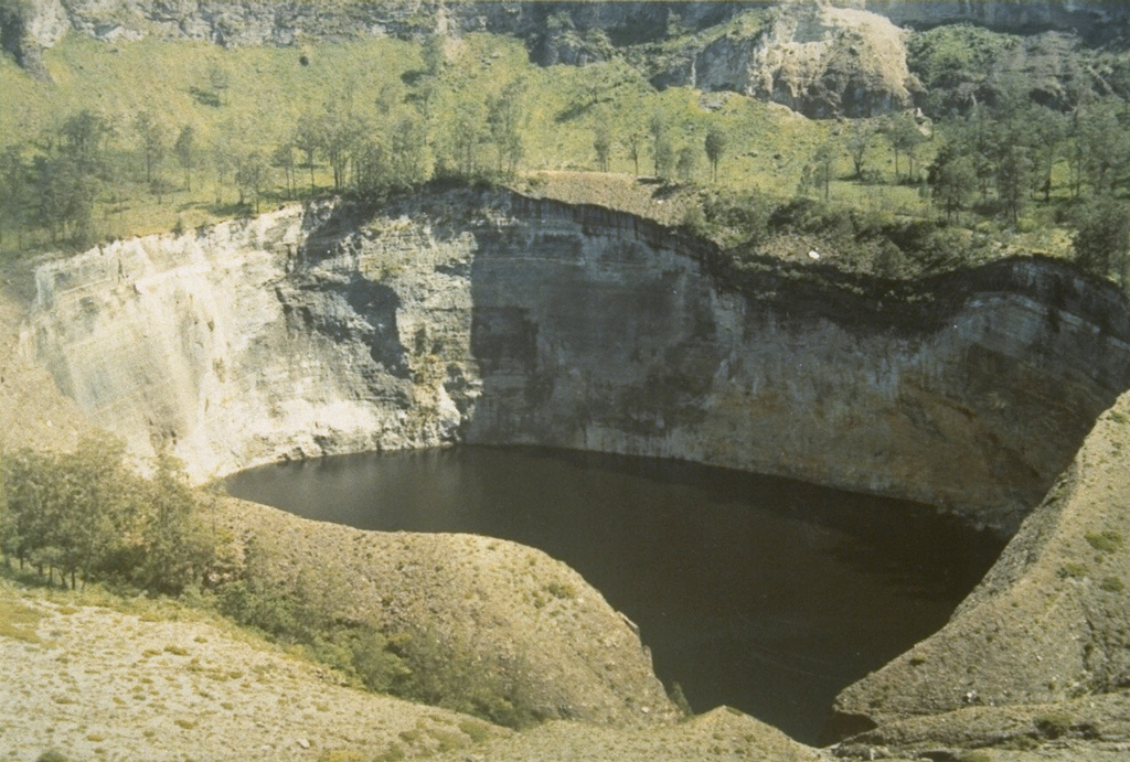 Tiwu Ata Mbupu is the NW-most of three craters on Kelimutu. It is 850 x 600 m wide and contains a 67-m-deep crater lake. The shoreline of the lake is coated with red/yellow minerals and gypsum crystals. Lake color tends to vary seasonally. Photo by L.D. Reksowirogo, 1972 (Volcanological Survey of Indonesia).