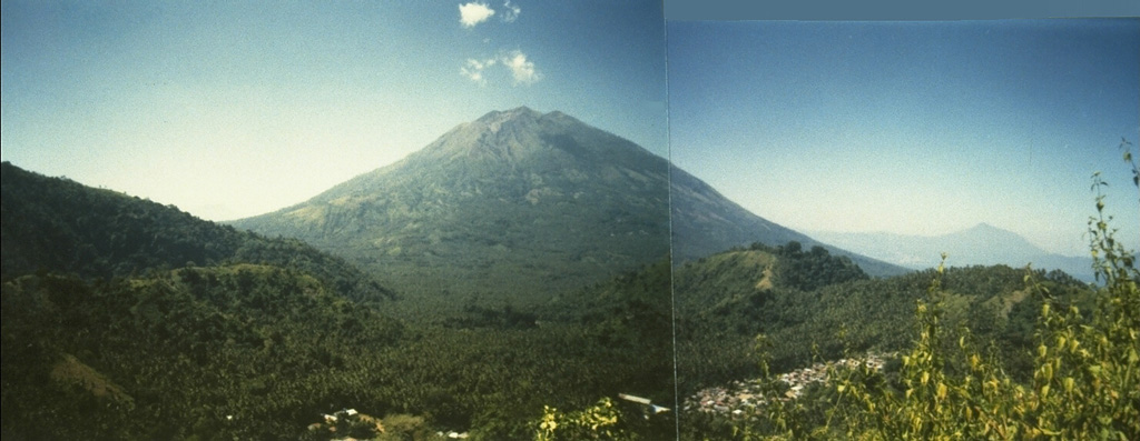 Iliboleng volcano at the SE end of Adonara Island, east of Flores Island, is a symmetrical stratovolcano with many partially overlapping summit craters.  Iliboleng is seen here from Bukit Tomu, north of the volcano.  Explosive eruptions from the summit crater have been recorded since 1885.  Only one historical eruption, in 1888, produced a lava flow. Photo by Willem Rohi, 1994 (Volcanological Survey of Indonesia).