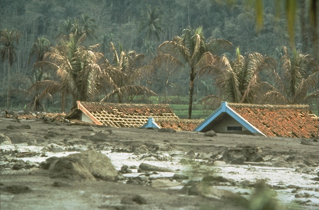 Lahars are water-saturated mixtures of volcanic debris that sweep down volcanoes and onto valley floors far beyond. These lahars from the 1982 eruption of Galunggung volcano on the Indonesian island of Java caused extensive damage to houses and croplands. Lahars can remain a hazard long after an eruption ends, when heavy rainfall redistributes deposits produced by the eruption. Photo by Robin Holcomb, 1983 (U.S. Geological Survey).