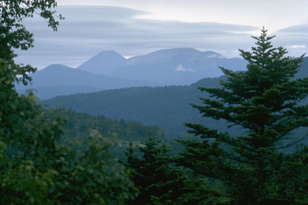 Meakan volcano (center) is flanked on the left by Akan-Fuji, one of many symmetrical Japanese volcanoes named after the renowned Mount Fuji. Meakan and Akan-Fuji are part of a cluster of nine cones constructed in the SW side of Akan Caldera. Photo by Lee Siebert, 1977 (Smithsonian Institution).