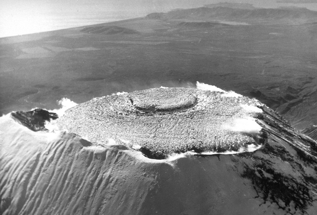 This October 1991 photo looks NW across the lava that filled the summit crater of Avachinsky during an eruption in January 1991. The eruption began on 13 January and produced ash plumes to 4-5 km above the crater. By the time the eruption ended on 30 January, the crater was 400-500 m wide, 250 m deep, and filled with lava to its rim. Lava spilled over the southern rim of the crater, producing lava flows that traveled 1.5 km down the SSE flank and short distances down the SW flank.  Photo by A. Obsyannikov, 1991 (Institute of Volcanic Geology and Geochemistry, Petropavlovsk).