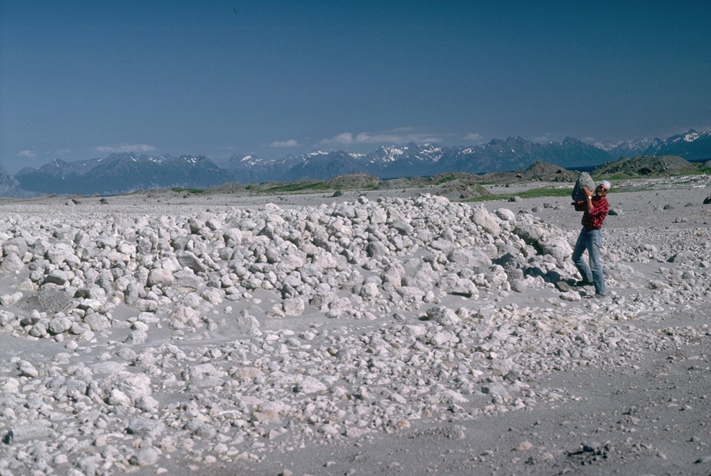 Volcanologist Jurgen Kienle holds a pumice clast at the toe of a 1986 pyroclastic flow deposit at Alaska's Augustine volcano. Thermal measurements more than 100 days after the eruption showed a maximum temperature of 525°C at a depth of 6 m. The flows traveled about 5 km from the summit and reached the sea on the N and NE coasts. Photo by Lee Siebert, 1986 (Smithsonian Institution).