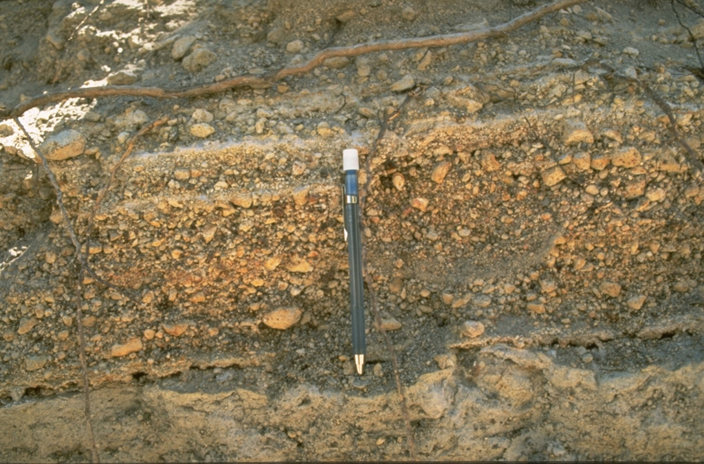 The Mono-Inyo craters produced explosive eruptions and effusive lava flows. The pumice layers above the bottom of the pen originated from the South Deadman vent of Inyo Craters about 600 years ago. Interbedded finer layers record brief pauses during the course of the eruption. Photo by Larry Mastin, 1986 (U.S. Geological Survey).