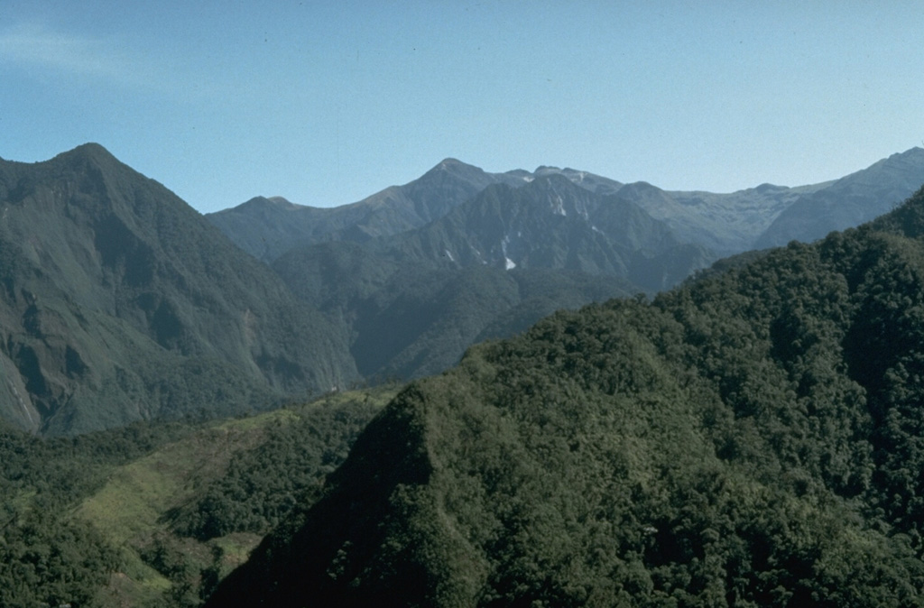 Atacazo stratovolcano, located 20 km south of Quito, is seen here from the west along the road to Guayaquil.  The volcano contains a summit caldera that is partially filled by lava domes of Holocene age.  Lava domes are also found on the SE flank.  The only dated Holocene eruption took place about 2400 years ago, forming the Ninahuilca lava domes, the peaks below the center horizon.     Photo by John Ewert, 1992 (U.S. Geological Survey).