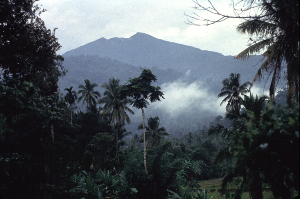 Sorikmarapi volcano rises above older mountains to the north. The truncated summit contains a crater lake and a chain of smaller NW-SE-trending craters. Eruptions have been recorded from both summit and flank vents since the 19th century. Anonymous, 1991.