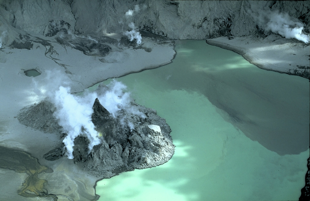 An eruption that began on 9 July 1992 produced a small tuff cone on the floor of the Pinatubo caldera. On 14 July a new lava dome was sighted, which by the end of the eruption on 30 October had grown to a height of more than 100 m and covered an area of 300 x 400 m. This view from the S shows the dome on 8 March 1993. Subsequent rise of the lake level covered much of the dome by 1994, leaving two small islands in the caldera lake. Copyrighted photo by Stephen O'Meara, 1993.