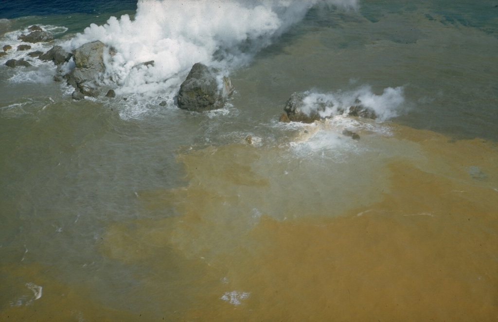 Steam emission from the blocky summit of a lava dome formed during a submarine eruption at the Beyonesu Rocks vent of the Myojinsho caldera in 1952. This 22 September photo was taken six days after the dome began to breach the sea surface. Later that day the eruption became highly explosive and the dome was destroyed. Three cycles of dome growth and destruction occurred until October 1953. Photo courtesy of Helen Foster, 1952 (U.S. Geological Survey).