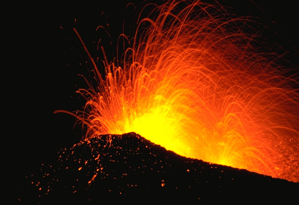 Incandescent bombs are ejected from the Oldugigar vent on the NNE flank of Hekla volcano during Strombolian activity in May 1970. This eruption began with vigorous explosive activity and was followed by effusion of lava flows that traveled to the SW, WNW, and N. The eruption lasted until July 1970. Photo by Robert Citron, 1970 (Smithsonian Institution; courtesy of William Melson)