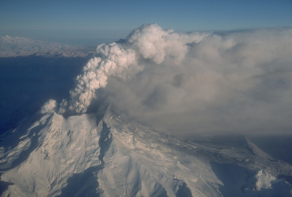 A gas-and-ash plume rises above Redoubt on 18 December 1989. The eruption began with a major explosion on 14 December that created a new vent in the summit crater. A lava dome was extruded in the new vent but was repeatedly destroyed by explosive eruptions. Pyroclastic flows and lahars often travel down the Drift River valley to the N and NE. Photo by W. White, 1989 (Alaska Volcano Observatory, U.S. Geological Survey).