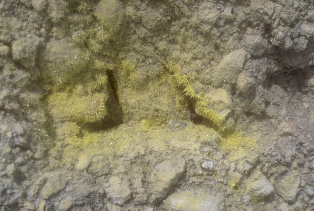 Sulfur mineralization surrounds a fumarole near the margin of a summit lake at Douglas volcano on the northern tip of the Alaska Peninsula. Photo by Chris Nye (Alaska Division of Geological and Geophysical Surveys).