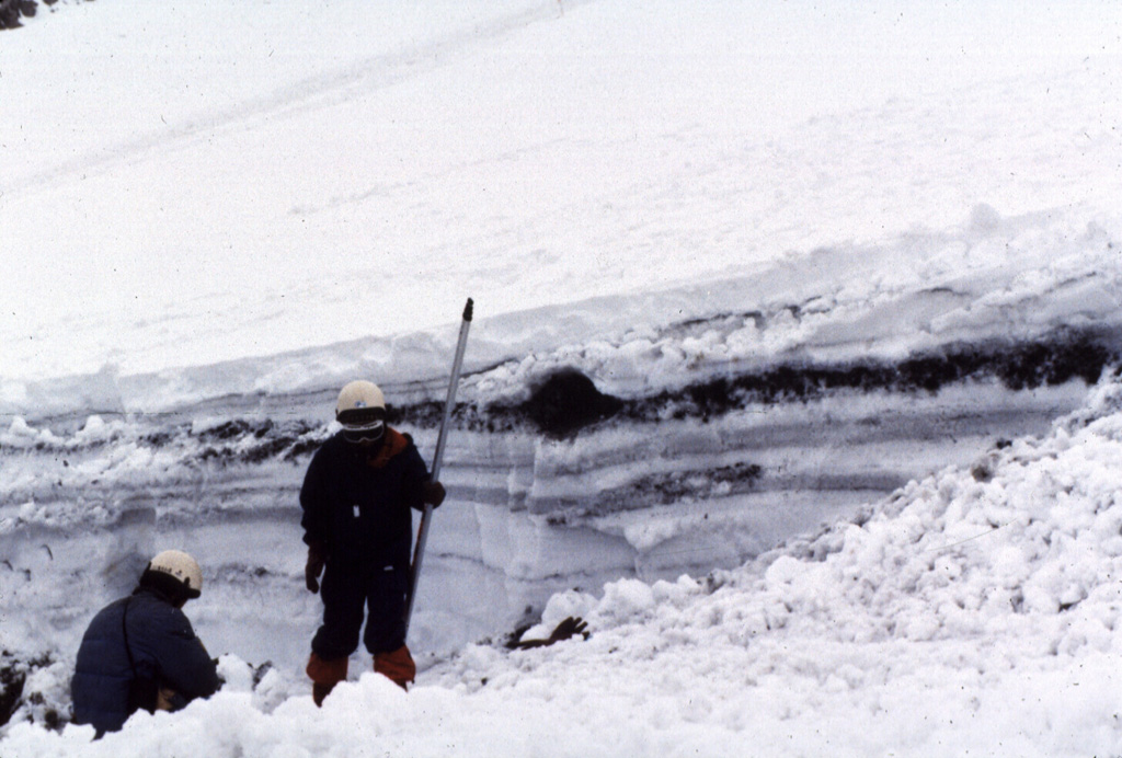 Snowpack on the western flank of Tokachi preserves individual layers of pyroclastic surge and pyroclastic flow deposits from the 1988-89 eruption. Because the eruptions took place during the winter, snowfall proved very useful to scientists in distinguishing the deposits of small-scale eruptions that lasted only a very short time. Photo by Mario Yoshida, 1989 (Hokkaido University).