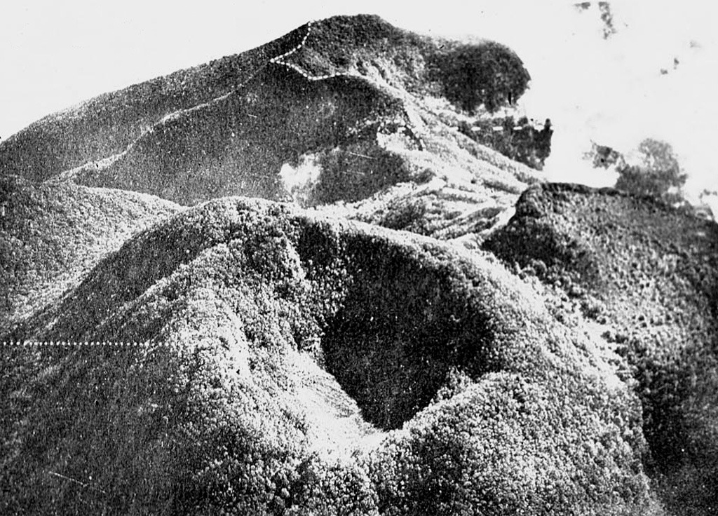 The summit of Guntur volcano is seen here in an aerial view from the SW with the crater of Gunung Masigit in the foreground. The forested 250-350 m wide crater is about 100 m deep. A smaller crater is to the top center below the Agung crater (top). The historically active crater of Guntur is off the photo to the right. Photo published in Taverne, 1926 