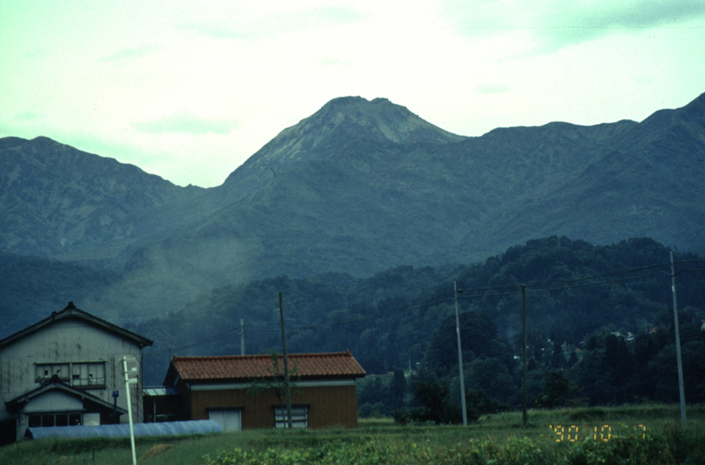 Niigata-Yakeyama, the peak in the center of the photo seen from the N, is a lava dome located in Niigata Prefecture. Yakeyama is a young volcano that was constructed beginning 3,000-3,500 years ago. Several craters formed at the summit and flanks of the dome during eruptions dating back to the 9th century. Photo by Yukio Hayakawa, 1990 (Gunma University).