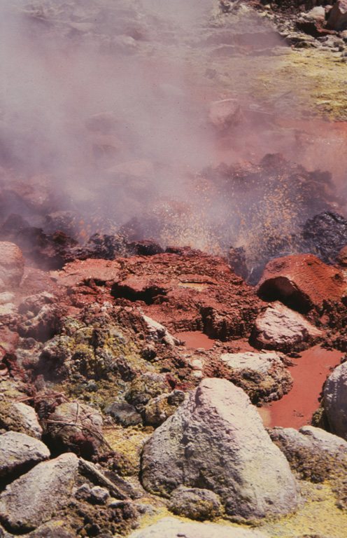 Bubbling mudpools at Ausoles de la Labor fumaroles on the northern flank of Laguna Verde volcano eject reddish oxidized mud onto the surrounding area. This is one of several prominent geothermal areas in the Apaneca Range. Hot springs are also found north of the Apaneca Range, particularly along the Agua Caliente and Escalante rivers. Photo by Rick Wunderman, 1999 (Smithsonian Institution).