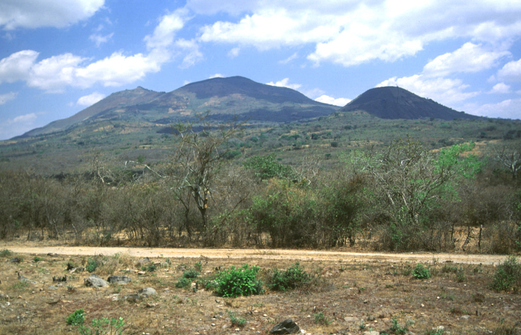 Ipala rises about 750 m above the floor of the Ipala graben. The edifice extends nearly across the full width of the graben. The cone to the right is Monte Rico on the southern flank. The eastern flank contains a 17 km NNE-SSW-trending vent that produced a line of Holocene scoria cones and lava flows out of view to the right. Photo by Giuseppina Kysar, 1999 (Smithsonian Institution).