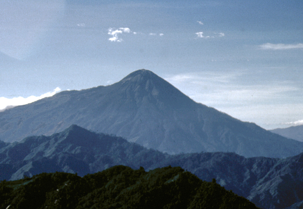 Tajumulco's southern flanks (left), which descend toward the Pacific coastal plain, are steeper than its northern flanks. At its base are exposed plutonic rocks. Photo by Bill Rose, 1986 (Michigan Technological University).