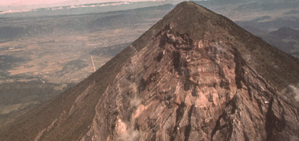 The catastrophic 1902 Santa María eruption formed a massive 1.5-km-wide crater in the SW flank. The upper part of the crater wall, which extends nearly to the summit of Santa María, is seen here from the SW. Guatemala's second largest city, Quetzaltenango, lies in the basin visible to the left, 10 km to the NNE. The 1902 eruption took place after a long period of quiescence that followed construction of the edifice. Photo by Sam Bonis (Instituto Geográfico Nacional).