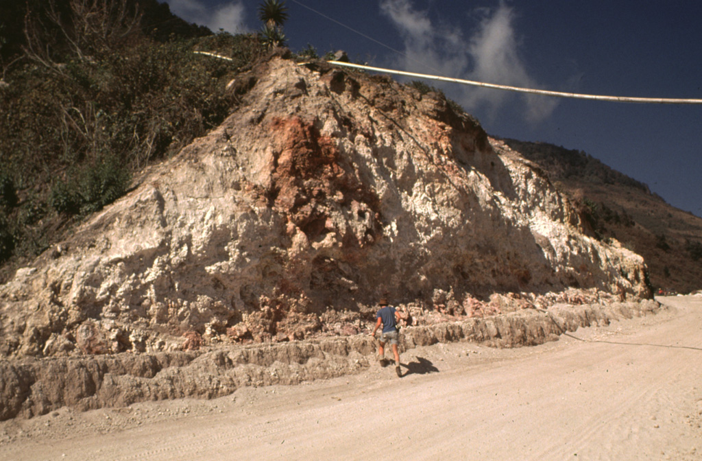 The rock around the Almolonga volcano Zunil geothermal field on the SE flank of Cerro Quemado volcano is extensively hydrothermally altered. The geothermal area is located along the Zunil fault zone, which juxtaposes brownish-red weathered to lightly altered andesite to dacite lava flows with white-to-pink heavily altered and brecciated volcanic rock. Hydrothermal alteration minerals include kaolinite, pyrite, gypsum, and alunite. The NE-SW-trending left-lateral fault zone runs parallel to the valley of the Río Samalá. Photo by Bill Rose, 1981 (Michigan Technological University).