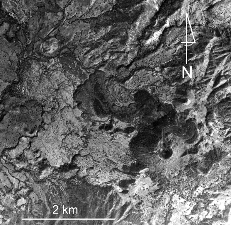 Jorullo volcano and associated lava flows in the Michoacan-Guanajuato volcanic field are visible in the bottom of this photo. Four NE-SW-trending vents flank the main cone, which erupted during 1759-1774. The 1759-74 lava flows appear in varying shades of gray, with the initial (and largest) flows being lighter in color (due to partial ash cover), and the most recent ash-free lava being darker and extending to the NW and NE. Jorullo lies about 80 km SE of Parícutin.  Aerial photo by Comisión de Estudios del Territorio Nacional (CETENAL).