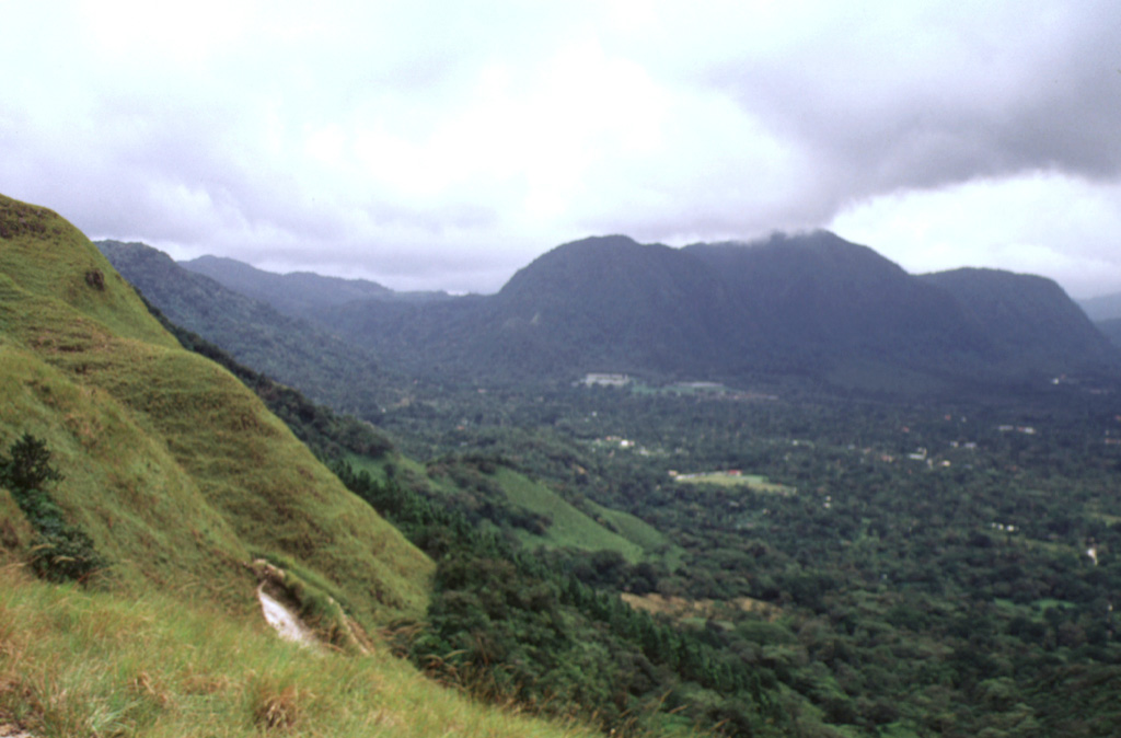 The post-caldera Cerro Pajita, Cerro Gaital, and Cerro Caracoral lava domes (seen left to right from La India Dormida on the western caldera rim) formed along an E-W trend about 900,000 years ago. The easternmost dome is Cerro Caracoral. Gabbro xenoliths are common in the central dome, Cerro Gaital. The Río Mar pyroclastic flows were produced about 40,000-50,000 years ago from a vent on the caldera floor between the Gaital and Pajita domes. Photo by Paul Kimberly, 1998 (Smithsonian Institution).