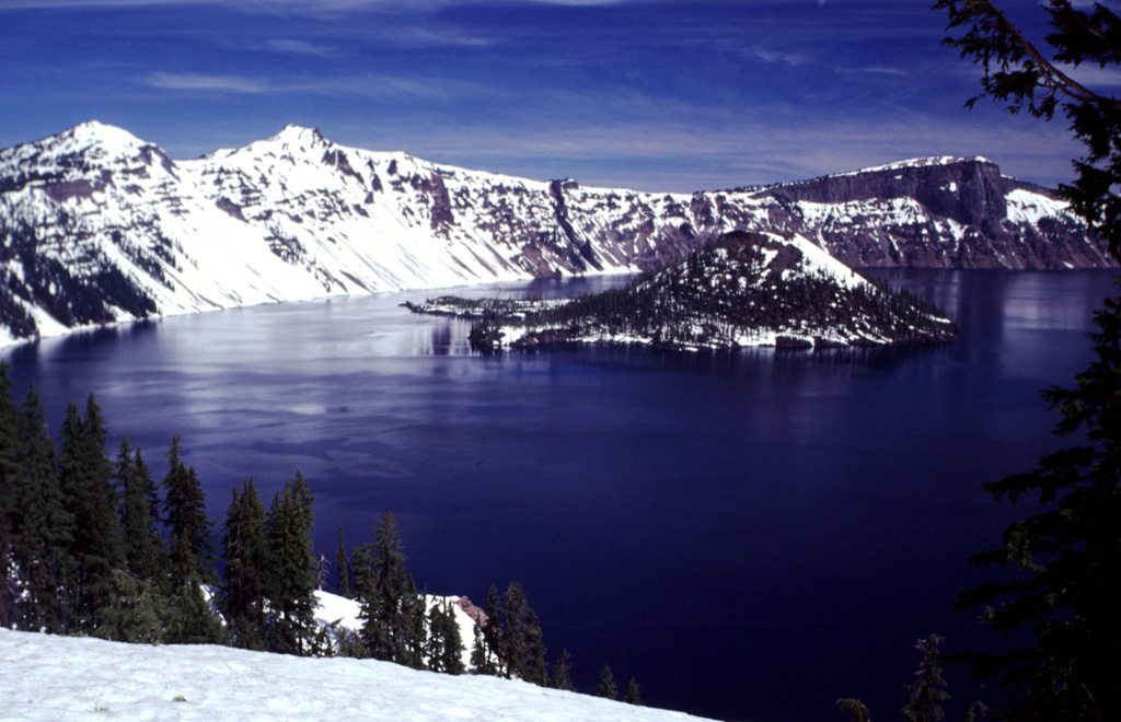 Volcanoes form some of Earth's most spectacular scenery and have been designated as national parks in many countries. The natural landscapes in these parks are a source of visual inspiration and varied recreational opportunities, and can also provide economic benefit to surrounding communities. Crater Lake National Park in the Oregon Cascade Range was established in 1902. This image looks across to Wizard Island and the western caldera rim from near the park visitor center and the Crater Lake Lodge. Photo by Lee Siebert, 1997 (Smithsonian Institution)