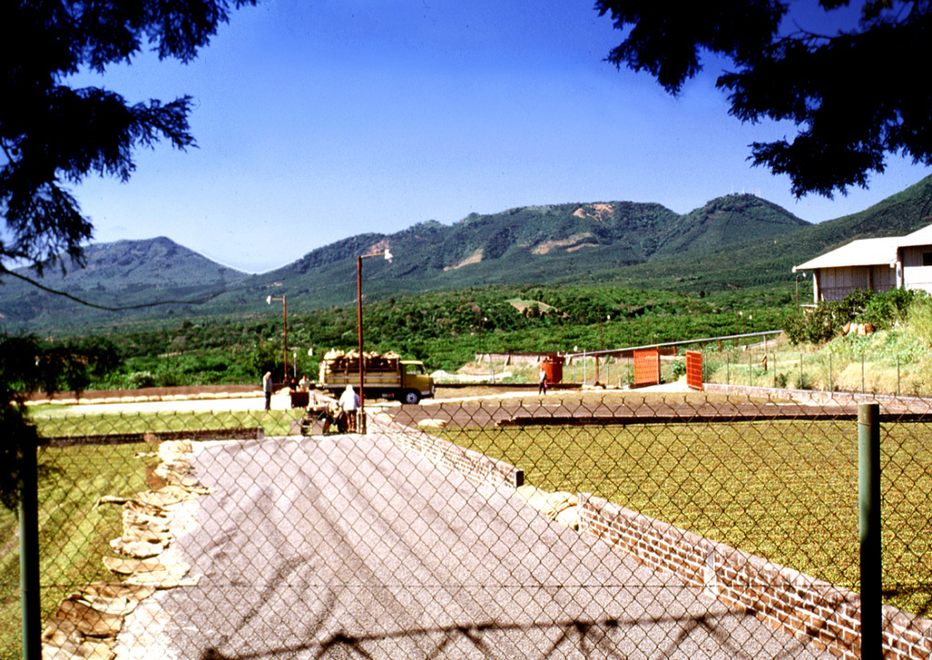 Coffee beans dry in the sun at a finca near the town of San José la Majada in the SE part of the Apaneca range. Coffee is the primary crop in this portion of El Salvador; fertile volcanic soil and abundant rainfall provide excellent habitat for coffee trees across the flanks of the volcanoes of the Apaneca range and Santa Ana massif. The Cerro las Ninfas-Laguna Verde complex forms the ridge on the horizon. Photo by Lee Siebert, 2002 (Smithsonian Institution).