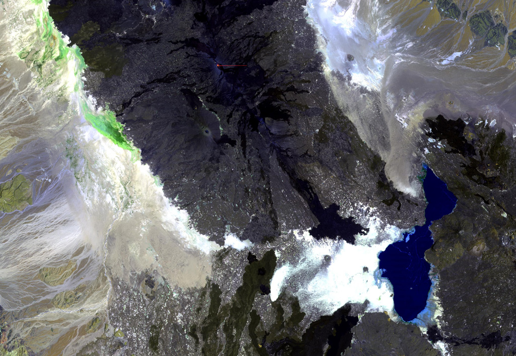 Ale Bagu, also known as Ummuna, is an elongate stratovolcano (left center) located SW of Erta Ale, the volcano at the top-center showing a small orange lava lake. In contrast to other volcanoes of the Erta Ale Range, Ale Bagu is mantled by basaltic pyroclastic rocks. The main crater is a steep-walled, 750 x 450 m depression. Trachytic lava flows occupy the crater floor and silicic lavas from the axial regional fissure extend to the NW and SE. Lake Giulietti (also known as Lake Afrera) is at the lower right. NASA Landsat image, 1999 (courtesy of Hawaii Synergy Project, Univ. of Hawaii Institute of Geophysics & Planetology).
