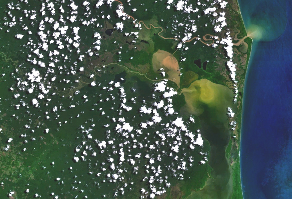 Volcán Azul (Volcán Blue) consists of three youthful cinder cones on the jungle-covered Atlantic coastal plain of Nicaragua.  The cones are located at the lower left, west of Pearl Lagoon (right-center) and south of both the Río Grande de Matagalpa (which flows from the upper left to form the small point north of Pearl Lagoon) and the Río Curinhuás (left-center), which flows into the northern end of the lagoon.  The three cones, each of which have well-defined, steep-walled craters, were first noted by geologists during an aerial overflight in the 1960s.   NASA Landsat 7 image (worldwind.arc.nasa.gov)