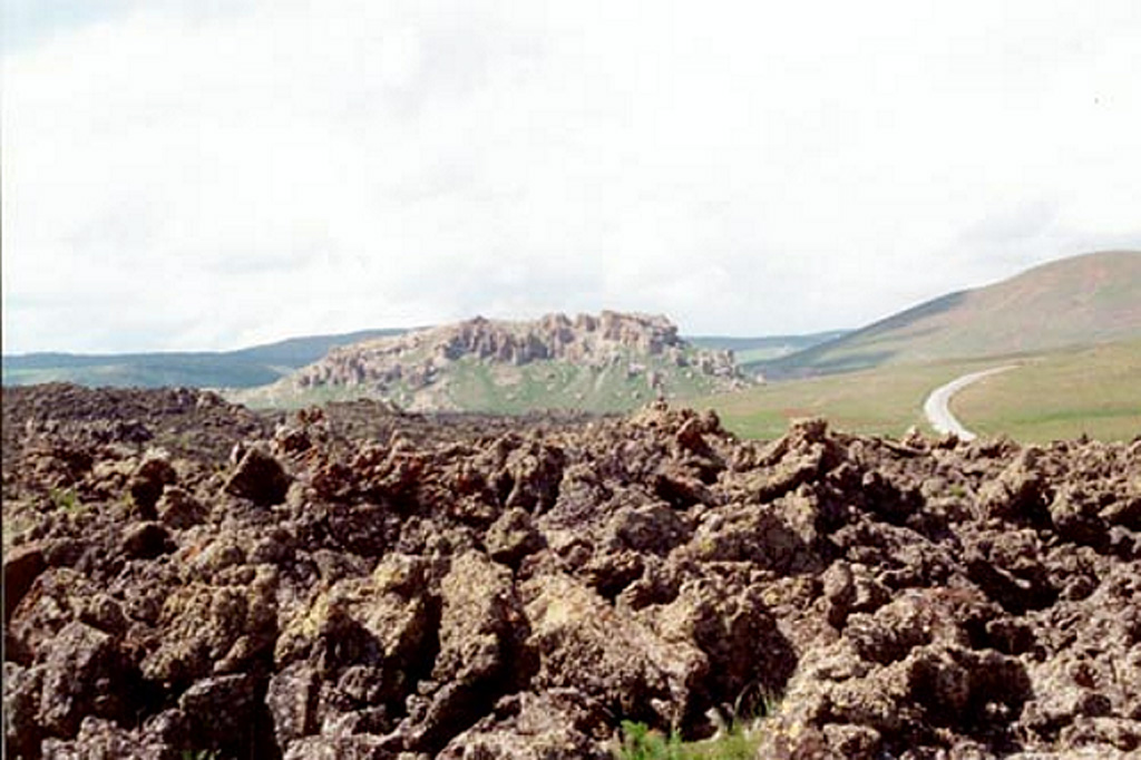 Rough `a`a lava flows in the foreground occupy the slopes of Tendürek Dagi volcano. This volcano rises 1,800 m above the plain of Dogubayazit, near the Iranian border, S of Mount Ararat. The latest activity formed two major basaltic lava flows from large cones on the NE and SE flanks. An eruption took place from a vent on the SE flank about 2,500 years ago, and an eruption took place in 1855. Photo by Joël Boyer, 1993 (L.A.V.E.)