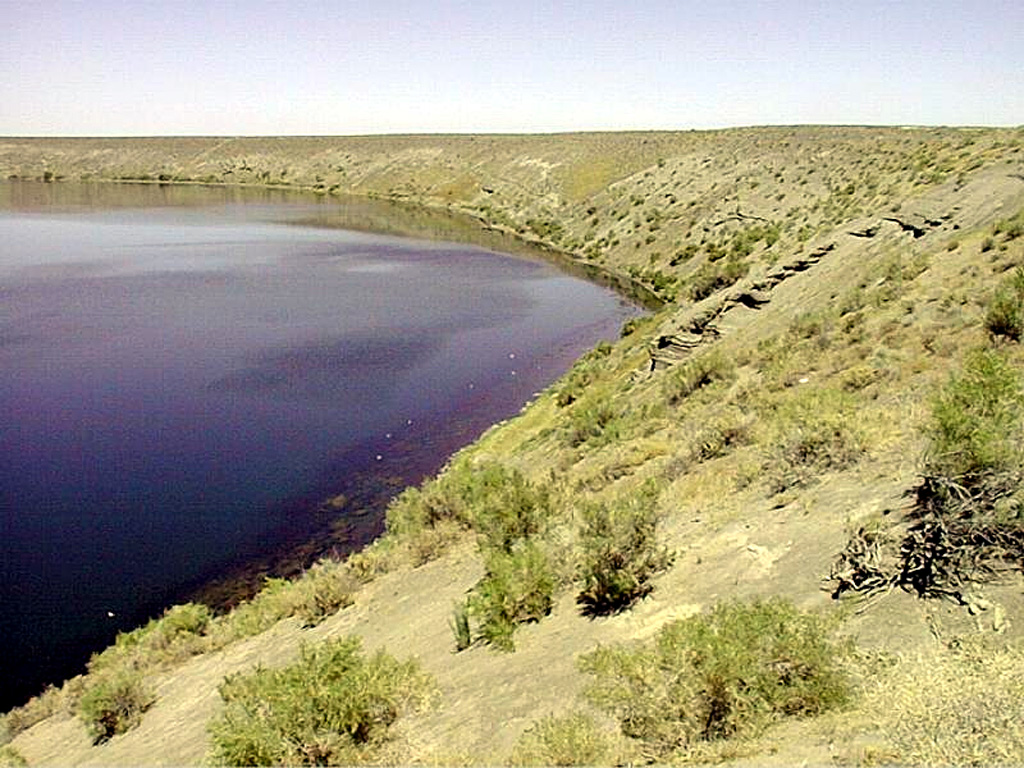 Soda Lake maar in west-central Nevada was erupted through sediments of the glacial Lake Lahontan.  It is the larger of two lake-filled maars located NW of the town of Fallon.  The basaltic maars were estimated to be less than 10,000 years old and perhaps even less than 1500 years old.  Soda Lake is about 1.3 x 2 km wide and is elongated in a NE-SW direction; its rim rises only about 35 m above the lake surface.  The maars are the site of a geothermal prospect that may have discharged hot springs through the end of the 19th century. Photo by Nevada Bureau of Mines and Geology.