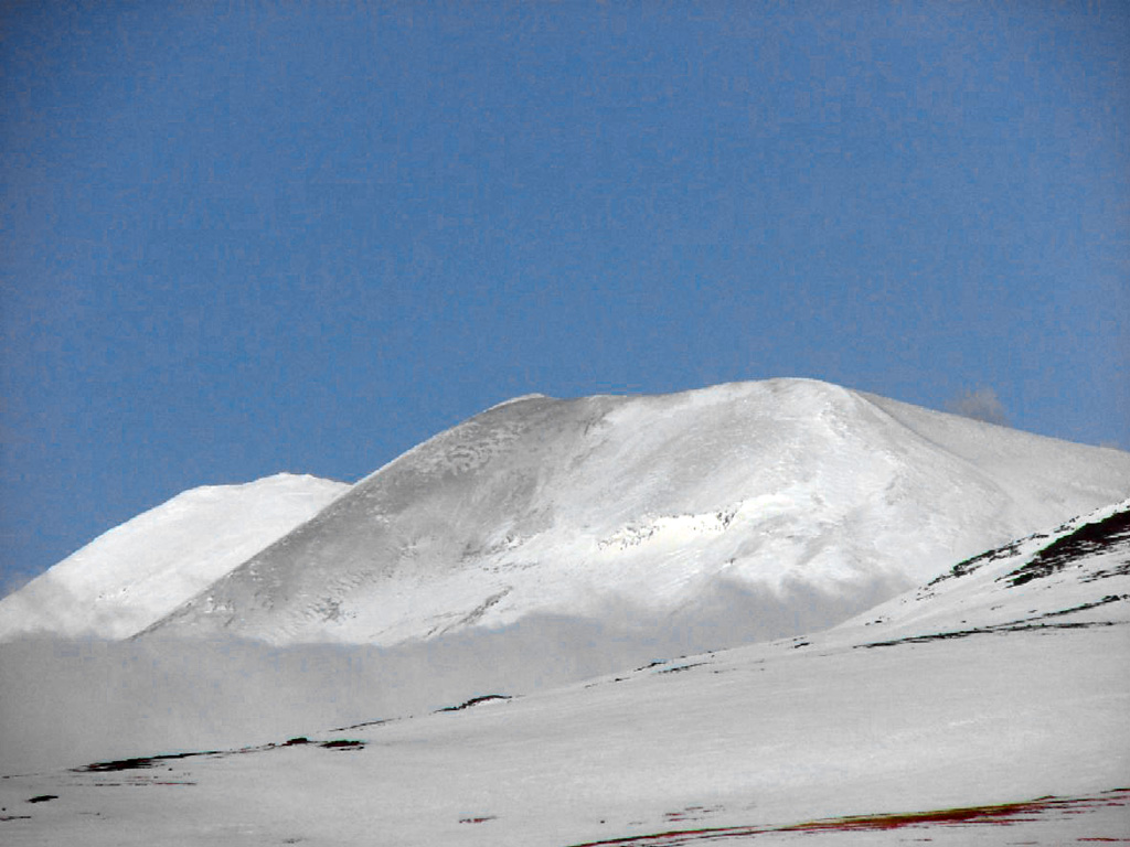 This photo taken on 3 March 2007 shows a light-gray ash deposit on the W flank of Korovin. In late November 2006 satellite images showed a light dusting of ash on the E flank of the main crater along with several plumes and/or their shadows visible along the N side of the crater. On 11 and 21 December 2006 Atka residents again witnessed steam plumes, possibly containing ash on the latter date. Photo by Kerry Moore, 2007 (courtesy of Alaska Volcano Observatory).