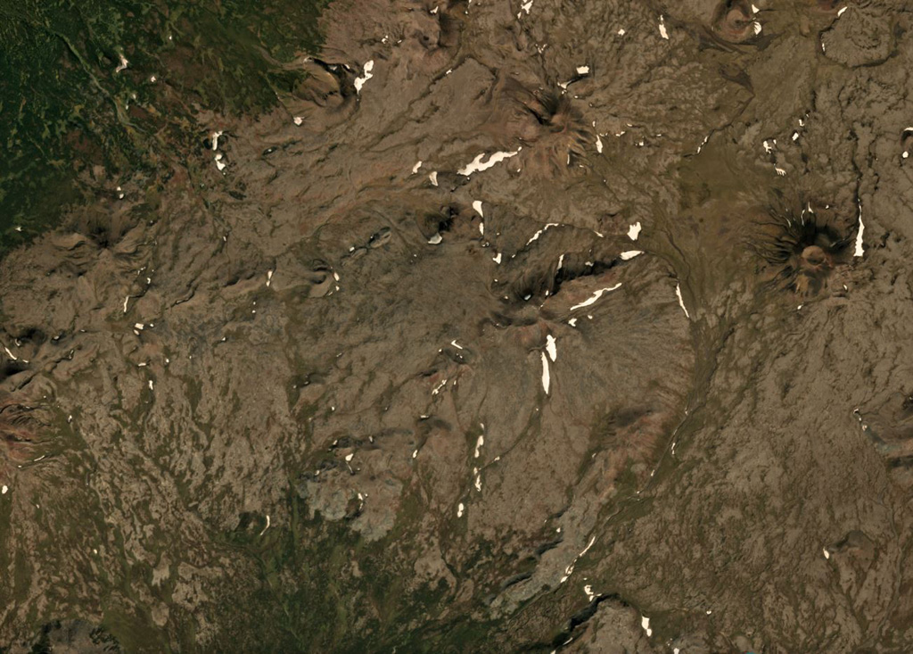 Activity at Tuzovsky shield volcano has formed several scoria cones visible in this September 2018 Planet Labs satellite image monthly mosaic (N is at the top; this image is approximately 13 km across). The cone to the right with a ~300-m-wide summit crater is Sredny, and 4 km NW is Tvitunup. The Tuzovsky cone is near the center of the image. Satellite image courtesy of Planet Labs Inc., 2018 (https://www.planet.com/).